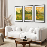 Living room with a white sofa, wooden coffee table, and three framed golf posters on the wall. Japan Golf courses posters.