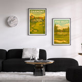 Two framed posters of Oakmont and Pine Valley on a wall above a black sofa.