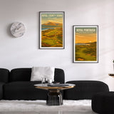 Two framed posters of Royal County Down and Royal Portrush displayed on a wall above a sofa.